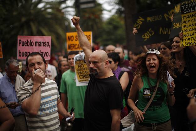 Demonstrators shout slogans during a demonstration in Malaga