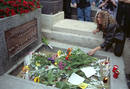 A woman puts flowers on the grave of lead singer of US rock group the Doors Jim Morrison on the 25th..