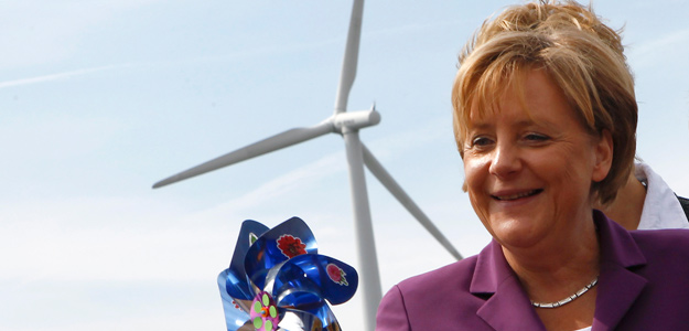 German Chancellor Merkel holds a windmill as she visits a wind turbine park 'WIND-projekt' in the northern German village of Ravensberg